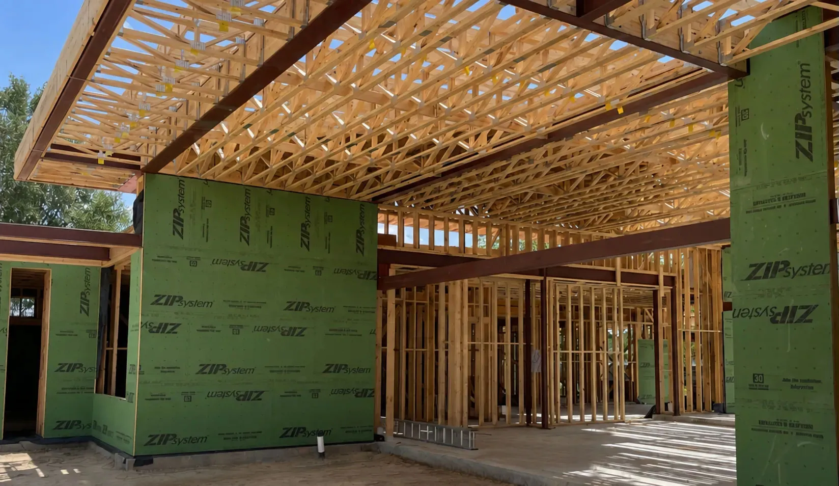 The field condition as built — long-span trusses, structural steel, and enclosure systems